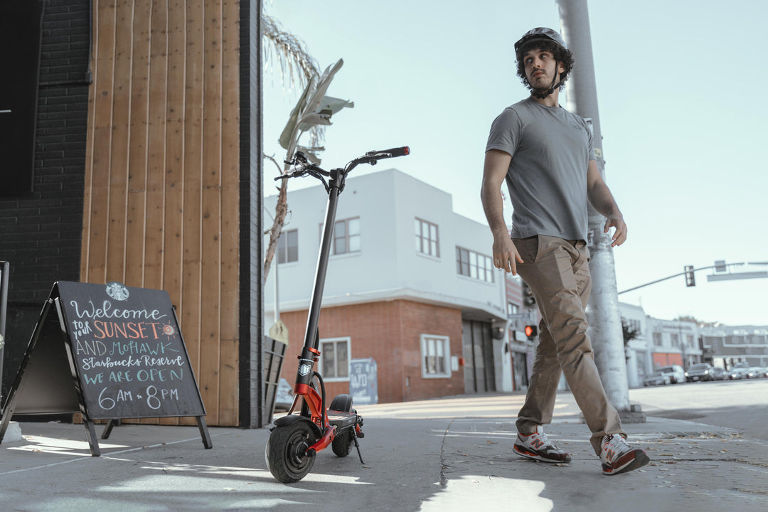 man with kaabo mantis 8 electric scooter
