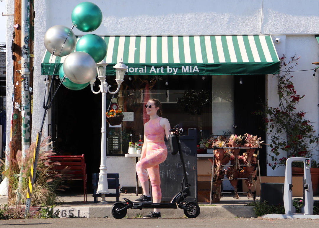 a woman with her Mantis 8 in front of a shop