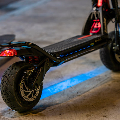 Kaabo Wolf Warrior 11 electric scooter showcasing under-deck LED lighting and robust dual-wheel design for night riding.