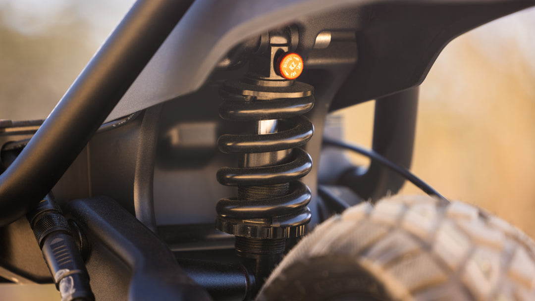 Kaabo Wolf Warrior 11 MAX rear suspension system close-up on off-road terrain