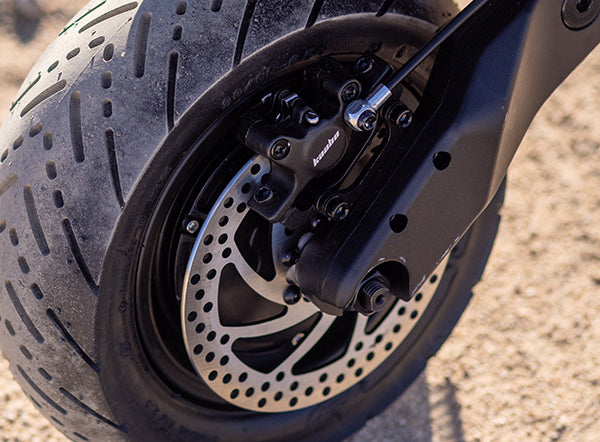 Close-up of the high-performance brake system on a Kaabo electric scooter, showcasing the meticulous design of the disc brake and calipers for optimal safety and control.