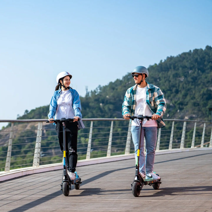 Two riders commuting on Kaabo Urban electric scooters on an outdoor path