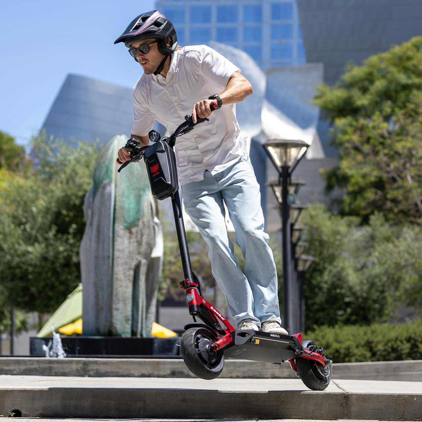 Rider cruising through the city on a Kaabo USA Mantis 10 Lite Electric Scooter